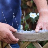 Defender® Narrow Stainless Steel Bird Spikes being installed easily on a fence with silicone