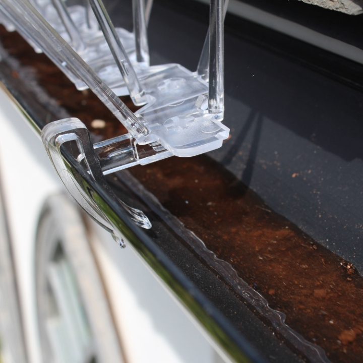 Defender® Gutter Spikes clipped on to guttering allowing water to flow freely under the spikes